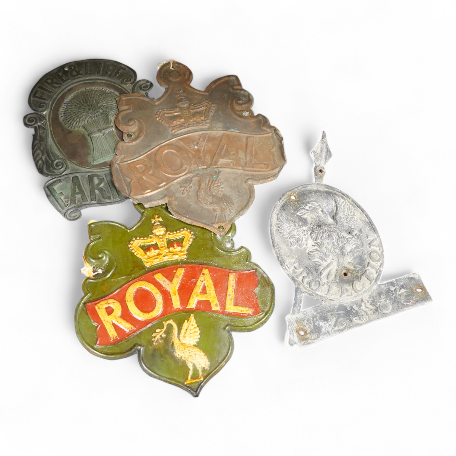 A collection of plaques to include a lead example and two copper examples one ‘Fire & Life, Farmers’, largest 30cm high